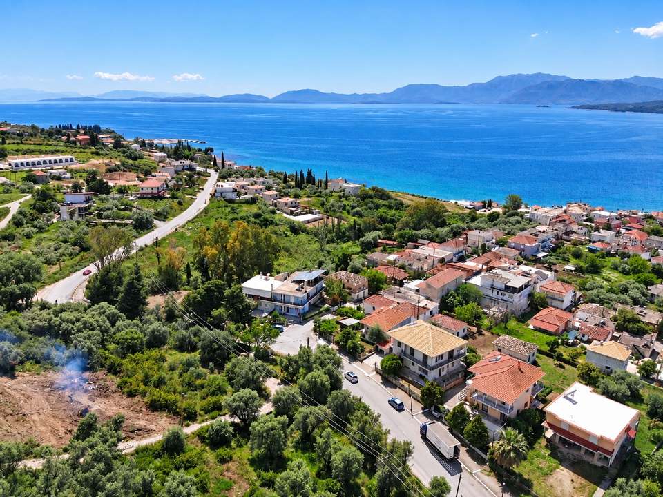 Aerial view of Paleros: red roofs, olive trees and the sea